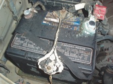 photo 2: a badly corroded battery is indicative of battery problems. the red accessory connector at the upper right is likely to be corroded as well.