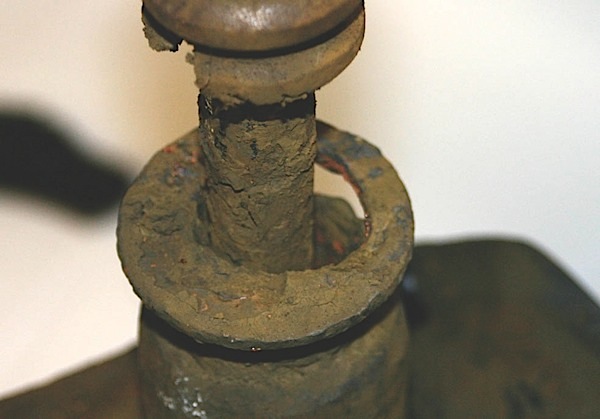 this rear strut shows the ultimate result of neglect and/or lack of inspection. the seal and upper part of the tube are completely gone. the housing has been distorted by braking forces.  the driver thought she had brake problems and did not notice the changes in vehicle behavior over the period of time it took the strut to degrade.   