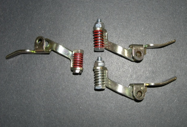 the holley carburetor pump arm on the left has the original duration spring design from the 1960s & 1970s. the new design pump arm on the upper right is more adjustable, but the duration spring is not as strong as the original design. the pump arm on the lower right has a duration spring that is used on the demon ­carburetors. the stronger duration spring makes the ­accelerator pump more active, which improves throttle response.