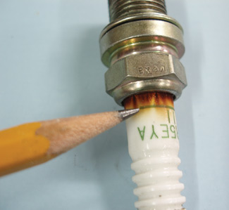 photo 2: over-tightening a new spark plug can cause combustion gas leakage past the ceramic seal on the spark plug.