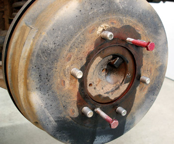 photo 4: puller bolts and penetrating oil is required to remove many ­import brake drums. a light film of synthetic caliper grease on the axle hub will reduce the tendency of the drum to seize to the hub. 