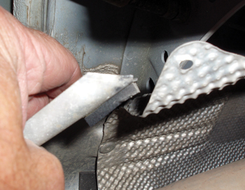 photo 2: exhaust shielding can be easily damaged and is very susceptible to vibration and inexpert re-installation.