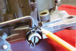 photo 6: metering rod travel can be easily checked by inserting an applicable tool into the front float bowl vent. 