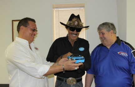 paul desantis (right) made a custom 1:18 scale diecast model of the richard petty tribute dodge challenger called legacy by petty for the vehicle’s owner, r.w. “bob” o’gorman, president of the automotive lift institute (ali) (left). petty (center) presented the model to o’gorman on desantis’ behalf at this year’s pettyfest.