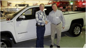 Winner Terry Fowler (left) congratulated by Auto Supply Co. Account Manager Dennis Adams.