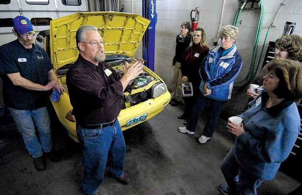 Car Care 101: Dave Crom, center, owner of Mountain Mechanical, talks to a group of women about car basics. At left is lead technician Ed Smith. (STEVE LEWIS/Herald)