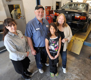 Tim and Renee Keeton of Woodstock, right, with their granddaugther Gabby Boone, 9, daughter of Angie and Leonard Boone, and Advanced Auto Parts representative Dawn Lynch of Kennesaw stand in front of the car the Keetons restored with the help of Advanced Auto Parts. (Cherokee Tribune/Anthony Stalcup)