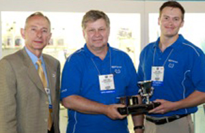 (left to right) Stephen Bearden, AIA Chairman, presents award to Helmut Ernst and Steve Landis of Continental Corporation with the 