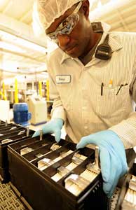 An Exide manufacturing associate examines an AGM battery being assembled in Columbus, GA.